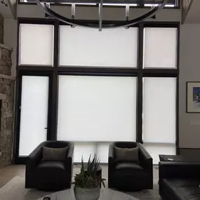 Tackle large and complex windows with custom cellular shades from GrandView Blinds & Designs. This great room showcases expertly fitted Hunter Douglas Duette honeycomb shades, offering excellent light filtration and energy efficiency for contemporary spaces with high ceilings and multi-section windows.