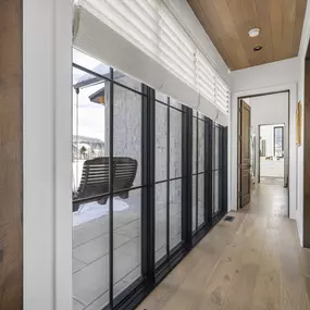 Enhance your hallway or large window areas with custom Roman shades from GrandView Blinds & Design. These elegant window treatments offer sophisticated style and light control, complementing architectural features.