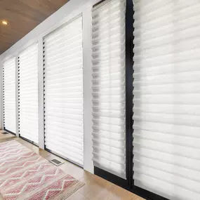 Add a touch of elegance and flexible light control to your space with layered Roman shades from GrandView Blinds & Design. Perfect for multiple windows in hallways or large rooms.