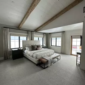 Combine styles for the perfect look with Roman shades and drapery from GrandView Blinds & Design. Layered window treatments offer versatile light control, privacy, and enhanced bedroom design.