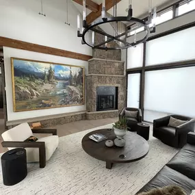 Control natural light and enhance your living room's ambiance with custom roller shades from GrandView Blinds & Design. A clean and modern window treatment solution for large windows.