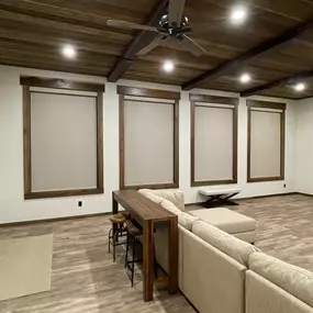 Enhance your space with versatile roller shades from GrandView Blinds & Design. These custom window treatments provide effective light control and privacy, beautifully complementing rooms with natural materials like wood.