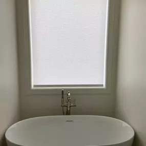 Enhance privacy and style in your bathroom with custom roller shades from GrandView Blinds & Design. A practical and clean window treatment solution for moisture-prone areas.