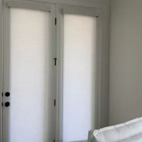 Gain privacy and light control for your glass doors with sleek roller shades from GrandView Blinds & Design. A modern and practical window treatment solution.
