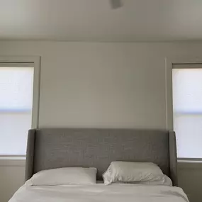 Create a serene bedroom environment with classic roller shades from GrandView Blinds & Design. Offering privacy and adjustable natural light, these shades are a perfect addition to any bedroom.