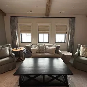 Combine elegance and versatility with layered window treatments from GrandView Blinds & Design. Featuring Roman shades and coordinating curtains, this look offers flexible light control and enhanced interior style for living areas.