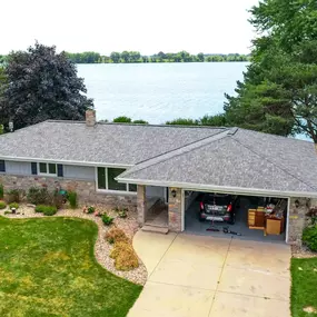 newly installed f wave shingles on home by a lake
