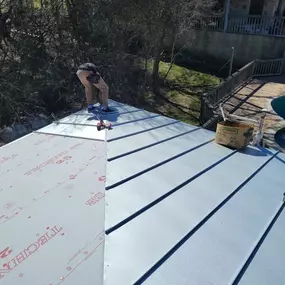 crew building standing seam metal roof