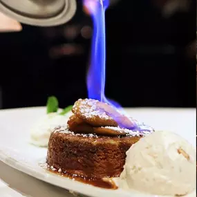 Our signature Bananas Foster is flambéed tableside and served with butter pecan ice cream.