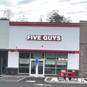 Exterior photograph of the Five Guys restaurant at 106 Storrs Road in Mansfield, Connecticut.