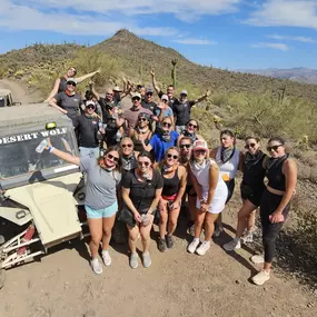 This lively group is all smiles after completing an exhilarating ATV tour with Desert Wolf Tours! With ATV rentals available, participants can explore the scenic Arizona desert while enjoying an unforgettable adventure off the beaten path.