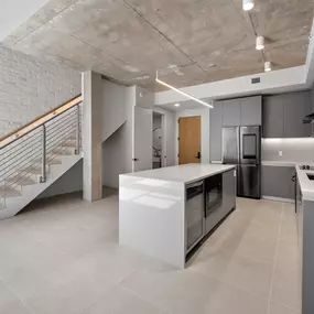 Modern loft-style apartment with an open kitchen, sleek finishes, and an industrial-inspired design.