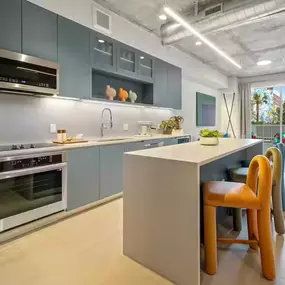 Modern kitchen with sleek cabinetry, industrial accents, and a spacious island for dining.