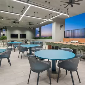 Spacious rooftop dining and entertainment area with open-air seating and skyline views.