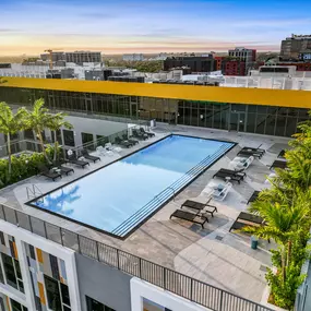 Stunning rooftop pool deck with resort-style seating and panoramic city views.