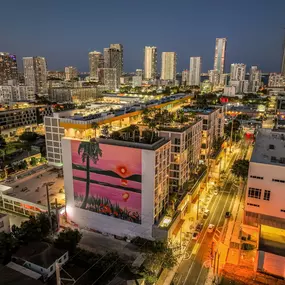 A stunning aerial view of the cityscape surrounding AMLI Wynwood at night, highlighting the beautiful skyline and vibrant lights of the area.