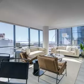 The living room at Encore Apartments offers stunning city views in a modern, comfortable setting.