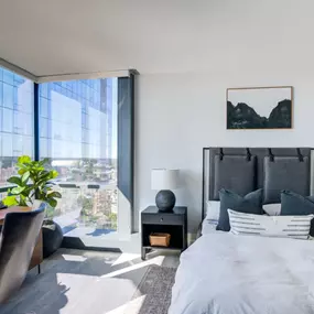 The bedroom at Encore Apartments offers a peaceful retreat with beautiful city views.