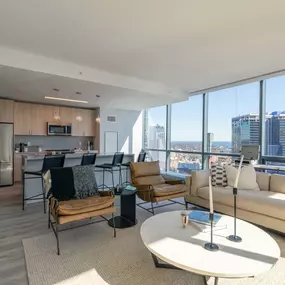 Encore Apartments feature an open-concept living, dining, and kitchen area with stunning city views.