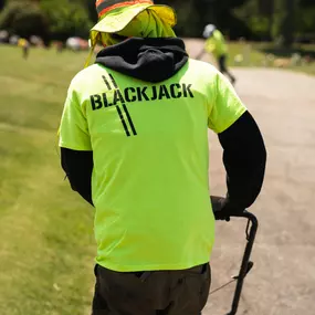 Contactor wearing a neon green t-shirt displaying Blackjack Paving's logo