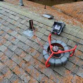 Camera inspection of a sewer line from the rooftop, allowing for accurate diagnosis and identification of blockages or damage.