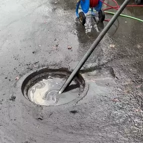 Hydro jetting process clearing a blocked drain using high-pressure water to remove debris and restore water flow. Essential for clearing stubborn blockages in sewer lines and drains, ensuring effective drainage.