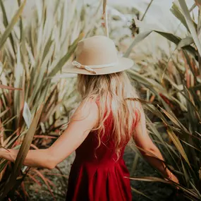 a girl in cornfield practicing self-care