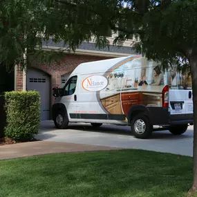 White N-Hance Wood Refinishing van outside of home