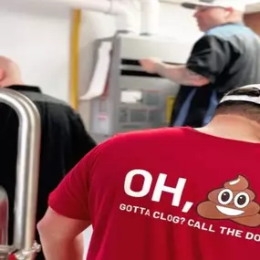 The Bulldog Rooter technician in the work shirt with their logo on it.