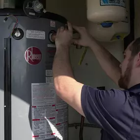 A Radiant plumber installs a water heater in a home