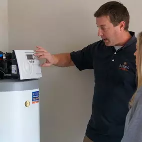 A Radiant Austin technician explains the water softener to the customer