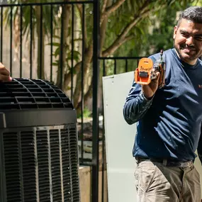 A Radiant Austin technician outside looking at an AC unit