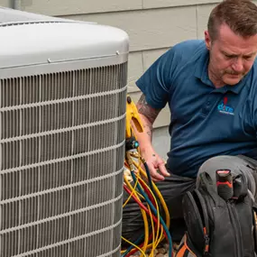 A Done HVAC technician repairing an AC system in the fall