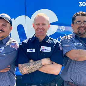 Done Plumbing, Heating, Cooling and Electric employees standing next to a truck