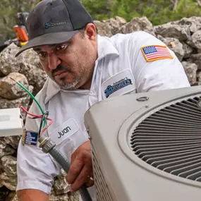 Juan an HVAC Technician working on a unit