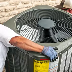 Two technicians installing a new AC system