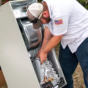 A 72 Degrees Texas HVAC technician working on a furnace