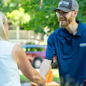 A Mainstream technician shaking hands with a customer