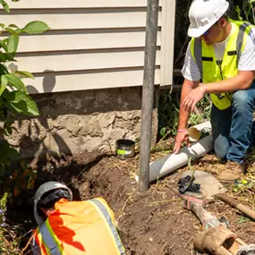 Mainstream Home Services plumbers excavating a pipe