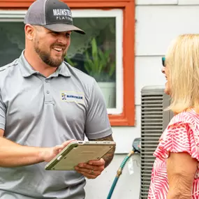 Mainstream technician going over paperwork with a customer