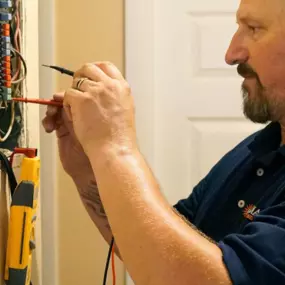 A Radiant San Antonio HVAC technician testing the electric panel for an HVAC installation