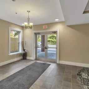 an empty entryway with a brick wall and a glass door at The Granite Works Apartments , Buffalo