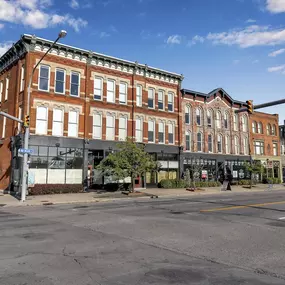 a large brick building on the corner of a city street at The Granite Works Apartments , Buffalo, NY