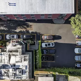 an aerial view of a building with cars parked in a parking lot at The Granite Works Apartments , New York
