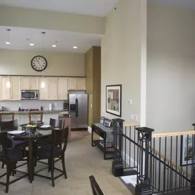 a dining room with a table and chairs and a kitchen at The Granite Works Apartments , Buffalo, NY