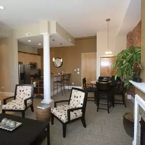 a living room with a table and chairs and a fireplace at The Granite Works Apartments , Buffalo, 14202