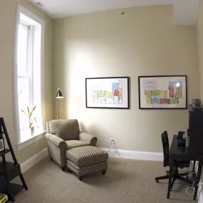 an office with a chair and a desk and a window at The Granite Works Apartments , Buffalo
