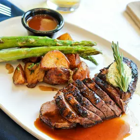 Prime 14 ounce New York strip with asparagus and potatoes