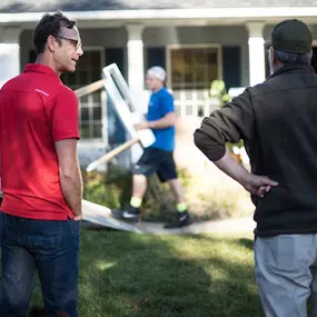 A homeowner discussing moving logistics with a member of the Adamantine Spine Moving team.