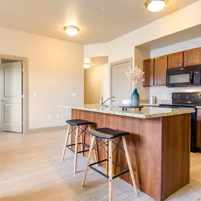 a kitchen with an island and stools